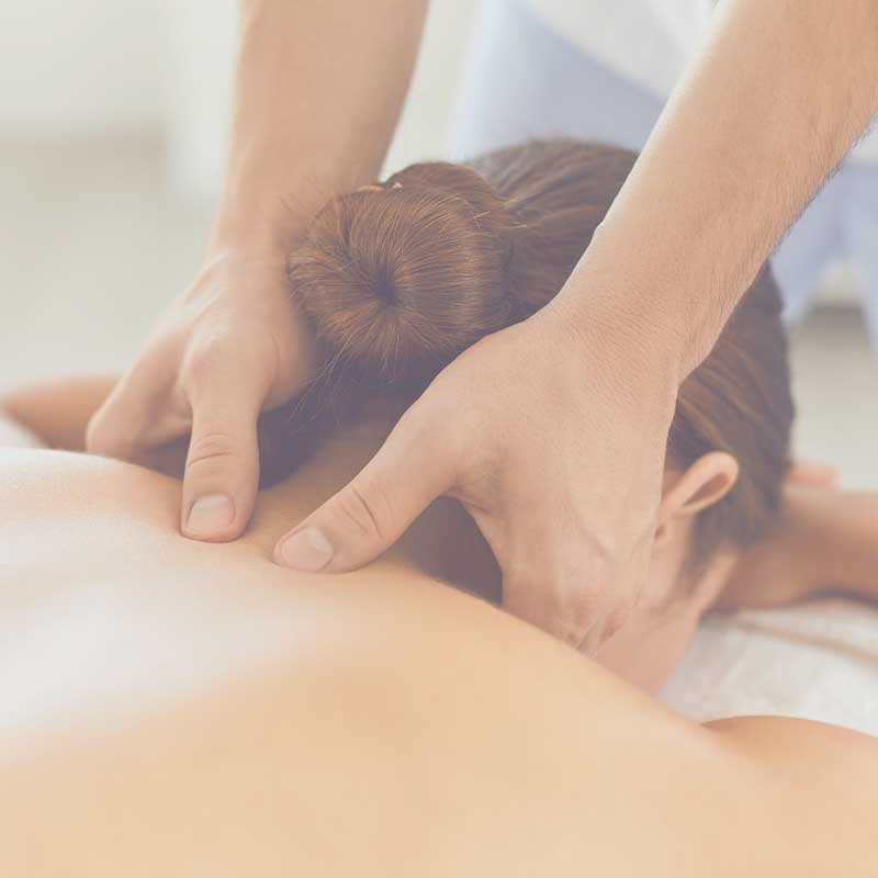 A women receiving a shoulder massage from a beauty therapist.